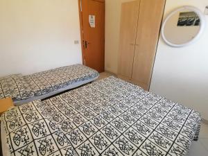 a room with two beds and a mirror at Euroholiday Village 3G in Lido di Jesolo