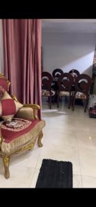 a living room with a bunch of chairs and a couch at Pyramids & GEM Tourist Apartment in ‘Ezbet `Abd el-Ḥamîd