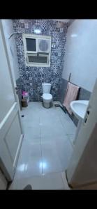 a bathroom with a toilet and a sink at Pyramids & GEM Tourist Apartment in ‘Ezbet `Abd el-Ḥamîd