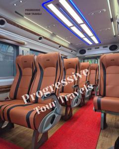a train car with orange seats and a red carpet at Ultra Premium Camper Van in New Delhi