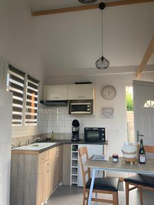 a kitchen with a table with chairs and a counter top at Chalet Honfleur in Honfleur