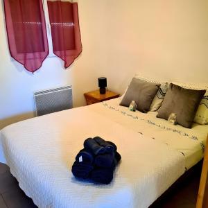 a bedroom with a bed with a backpack on it at Chalet Honfleur in Honfleur