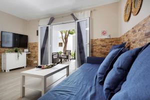 a living room with a blue bed and a tv at Plus Romance in Puerto del Carmen