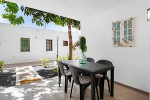 a black table and chairs on a patio at Plus Romance in Puerto del Carmen