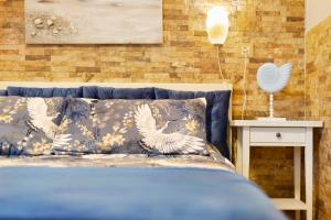 a blue bed with pillows on it in a bedroom at Plus Romance in Puerto del Carmen +17 photos