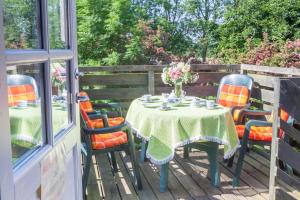 a table and chairs sitting on a deck with a table and chairs at Ferien Auf Dem Lande in Scheggerott