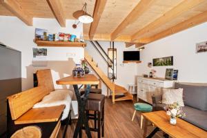a tiny apartment with a staircase and a living room at Naturhäusle Oberschwaben in Ebersbach-Musbach