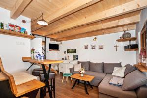 a living room with a couch and a table at Naturhäusle Oberschwaben in Ebersbach-Musbach +10 photos