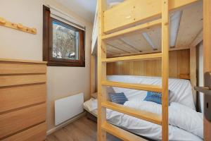a bedroom with bunk beds in a tiny house at Appartement St so in Saint-Sorlin-dʼArves