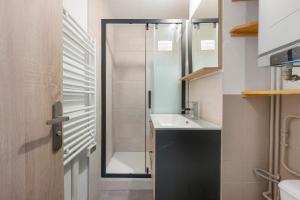 a small bathroom with a sink and a shower at Appartement St so in Saint-Sorlin-dʼArves +18 photos