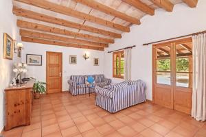 a living room with two chairs and a table at Finca L'hort Nou in Pollença +19 photos