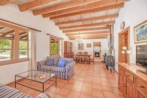 a living room with a couch and a table at Finca L'hort Nou in Pollença