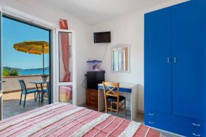 a bedroom with a bed and a desk and a table at Sciabattica - Lacona in Lacona