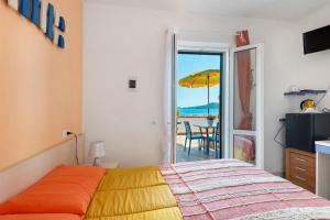 a bedroom with a bed and a view of the ocean at Sciabattica - Lacona in Lacona