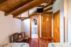 a room with a bed and a desk and a sink at Casa Rural El Agero in Cabañes