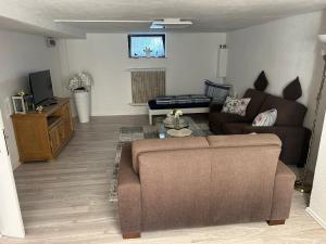 a living room with a couch and a tv at Ferienwohnung Princesa in Geilenkirchen