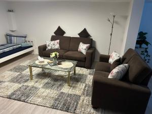 a living room with a couch and a coffee table at Ferienwohnung Princesa in Geilenkirchen