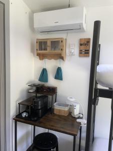 a kitchen with a wooden table with a stove and a hood at Cozy little hideaway in Balatonfüred