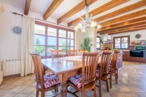 a dining room with a wooden table and chairs at Son San Marti Gran in Can Picafort