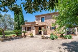 a stone house with a large driveway at Son San Marti Gran in Can Picafort