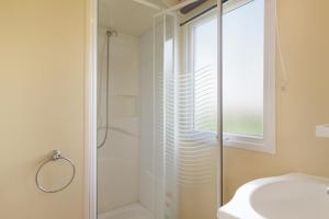 a glass shower in a bathroom with a sink at Calma in Barbate
