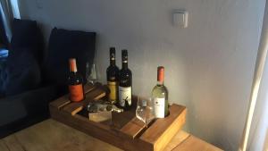 a bunch of bottles of wine sitting on a shelf at Gemütliches Refugium im Klosterdorf in Neustadt am Rübenberge +11 photos