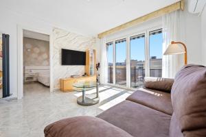 a living room with a couch and a glass table at Apartment with spa and bbq in El Vendrell