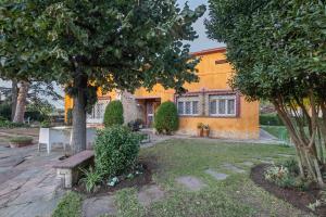 a yellow house with a table in the yard at Tordera Village in Tordera