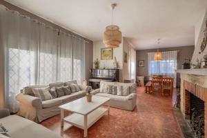 a living room with a couch and a fireplace at Tordera Village in Tordera