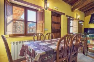 a dining room with a table and chairs and a window at Aldaron in Boca de Huérgano