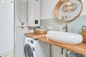a bathroom with a sink and a washing machine at Casa El Camaleón in Almuñécar +23 photos
