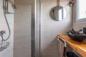 a bathroom with a shower with a sink and a mirror at Gite Du Ptit Lou in Noyers-sur-Cher +24 photos