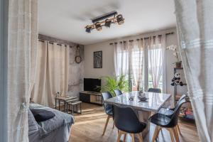 a living room with a table and chairs at Gite Du Ptit Lou in Noyers-sur-Cher