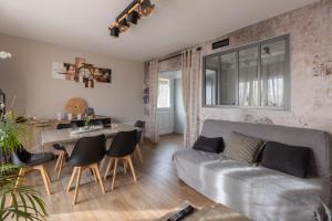 a living room with a couch and a table at Gite Du Ptit Lou in Noyers-sur-Cher