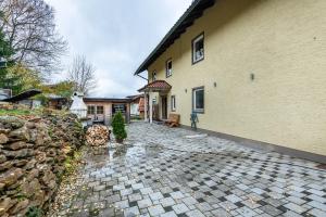 a house with a stone walkway next to a building at Ferienwohnung am Silberberg in Bodenmais
