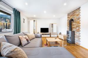 a living room with a couch and a fireplace at Ferienwohnung am Silberberg in Bodenmais