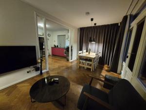 a living room with a couch and a table at B&B Lisa Groningen in Haren