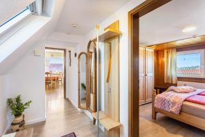 a bedroom with a bed and a dining room at Casa Felicitas Fewo und Studio in Möhnesee