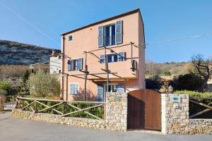 a house with a gate in front of it at Casa Virginia - Corbezzolo in Orco Feglino