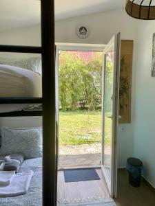 a room with a bed and a sliding glass door at Cozy little hideaway in Balatonfüred +8 photos