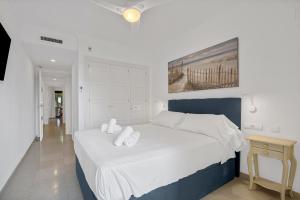 a white bedroom with a large bed with white pillows at Villa Gadea 4-2 in Altea +32 photos