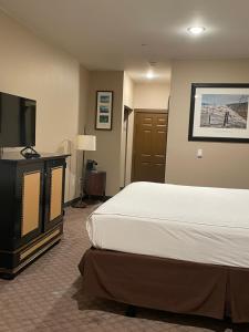 a hotel room with a bed and a television at Wagon Wheel Yellowstone in West Yellowstone