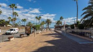 a van parked on a sidewalk next to the beach at Exclusive Sonemar in Maspalomas