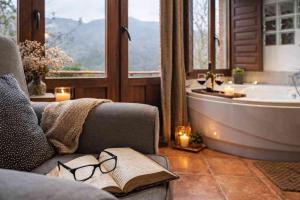 a living room with a book and a bath tub at El Ablanu, jacuzzi y vistas in Proaza +36 photos