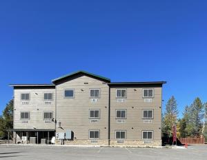 a large gray building with a black roof at Wagon Wheel Yellowstone in West Yellowstone
