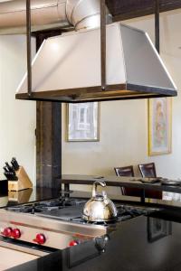 a silver tea kettle on a stove in a kitchen at Two Bedroom, Two Newly Renovated Bathrooms, Deck in San Francisco +27 photos
