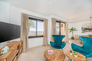 a living room with a television and a table and chairs at Cana Ferrera in Port de Pollensa