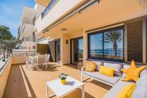 a patio with a couch and a table at Cana Ferrera in Port de Pollensa