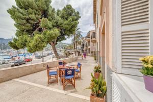 a table and chairs on a balcony with a view of a harbor at Cas Mariner Puerto de Sóller in Port de Soller