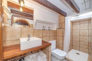 a bathroom with a sink and a toilet at Cas Mariner Puerto de Sóller in Port de Soller +17 photos
